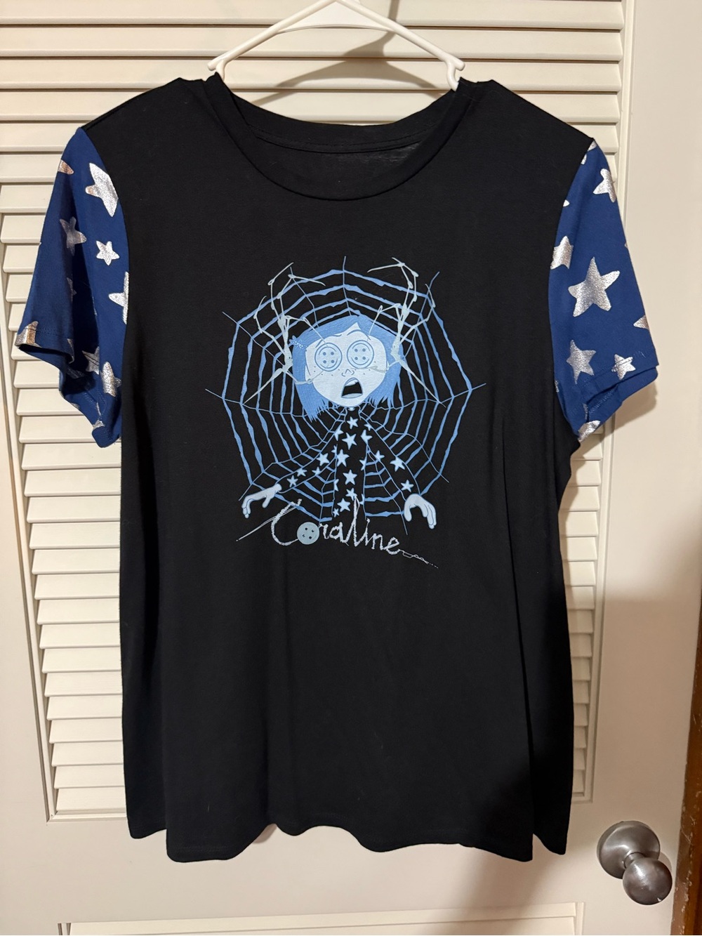 Coraline Black Tee with Blue Star Sleeve Graphic